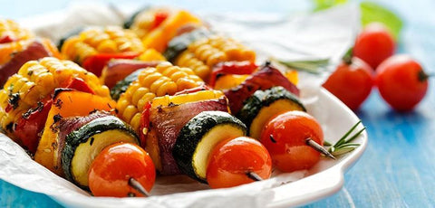 Vegetable kebab with tomatoes, zucchini, corn, onions and peppers