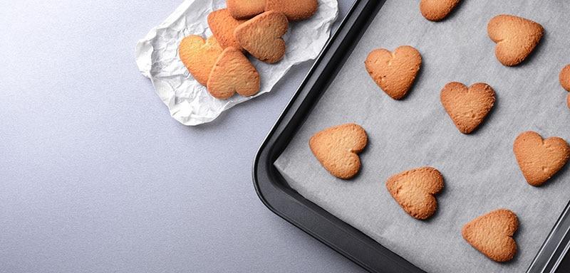 heart shaped cookies on parchment paper baking pan