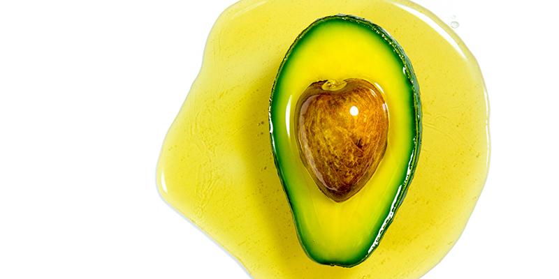 Half an avocado sitting in avocado oil