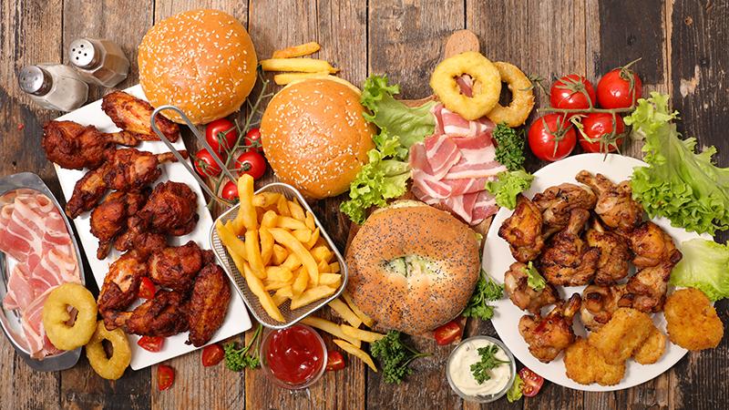 American food buffet chicken wings, french fries, burgers, ketchup